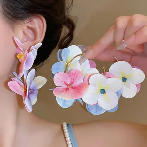 Detailed macro view of vibrant multi-layered fabric flower petal earrings in pastel colors