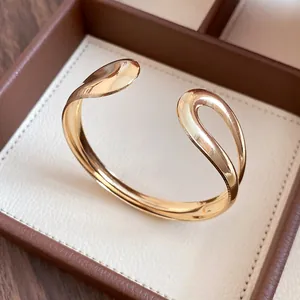 Detailed close-up showing the elegant polished gold waterdrop open cuff bracelet design