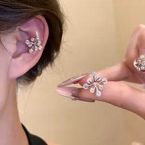 Detailed macro view of a sparkling zircon flower ear bone clip with a silver-plated finish