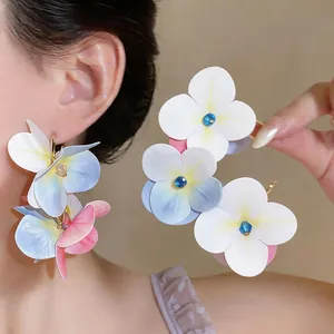 Elegant layered floral fabric earrings with gradient petals and blue crystal center