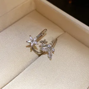 Close-up of elegant silver floral ear cuffs with sparkling marquise zircons in a box