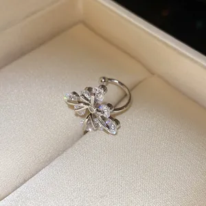 Detailed macro view of an elegant silver zircon flower ear cuff inside a velvet box