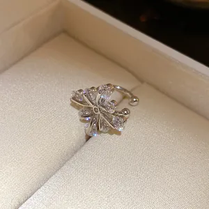 Detailed close-up of elegant flower zircon ear cuff in silver finish inside gift box