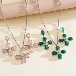 Elegant detail view of the pink and green resin pleated flower necklace and earring set