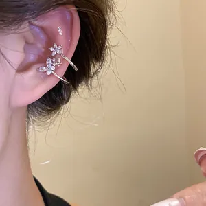 Elegant silver zircon flower and butterfly ear cuffs for women shown on ear cartilage