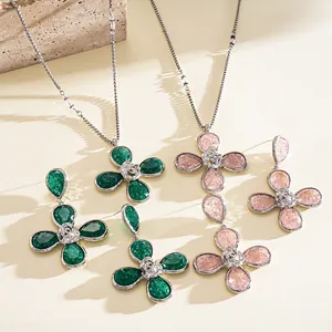 Detailed macro view of resin four-leaf flower necklace and earrings with wrinkled texture
