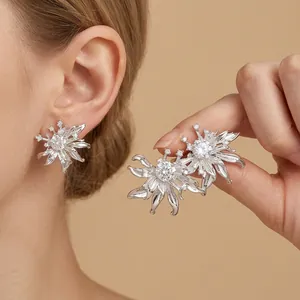 Elegant French vintage sunflower stud earrings with sparkling crystals on model's ear