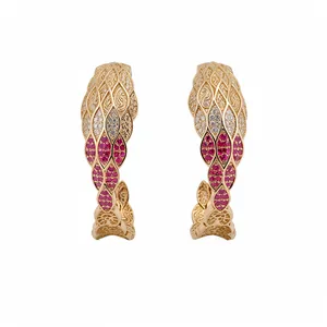 Vintage gold C-shaped hoop earrings with clear and red zircon stones and filigree detail