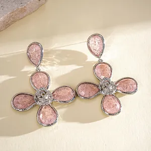 Detailed macro view of pink resin flower earrings featuring wrinkled texture and silver-tone finish.