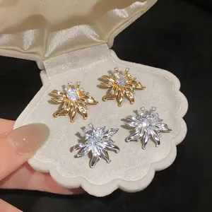 Macro view of French retro sunflower stud earrings with crystals in a shell box