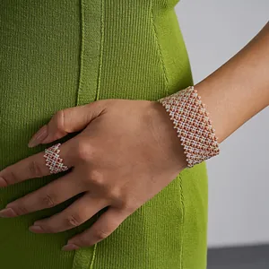 Close-up of geometric glass bead magnetic bracelet and matching ring on elegant model