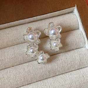 Eleganti orecchini asimmetrici a fiori e perle in argento in una scatola da regalo