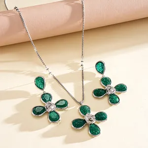 Close-up of green pleated flower jewelry set with necklace and matching earrings