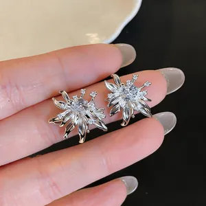 Macro view of French vintage sunflower stud earrings with sparkling inlaid crystals.