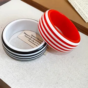 Modern striped resin bangles featuring a minimalist round design in black and red colors