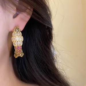 Vintage gold-plated C-shaped earrings encrusted with sparkling pink and white zircons