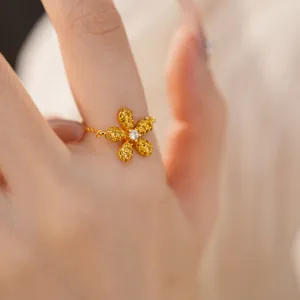 Gros plan détaillé d'une bague fleur dorée avec des cristaux jaunes et blancs brillants
