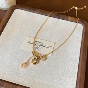 18K gold plated zircon star and safety pin pendant necklace on wooden display tray