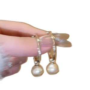 French style minimalist gold hoop earrings with elegant hanging pearl charms.
