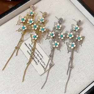 Elegant butterfly and flower stud earrings with long tassels in gold and silver finishes