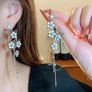 Elegant silver needle tassel earrings with rhinestone butterflies and flowers.