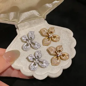 Elegant sparkling butterfly flower stud earrings set in silver and gold plating