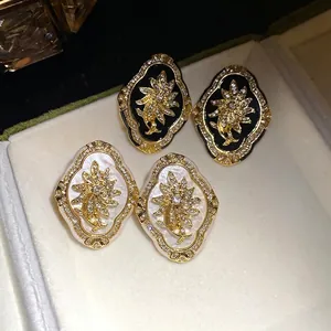 Elegant vintage style floral stud earrings featuring glittering rhinestones and gold frames