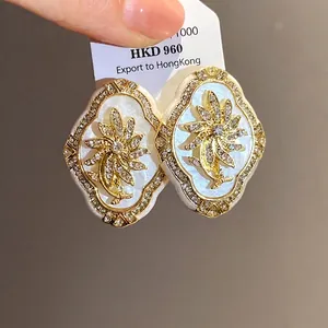Vintage floral stud earrings with rhinestones and silver needles in a retro court style