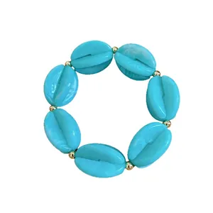 Vibrant turquoise acrylic marbled beaded necklace with elegant gold accents on white