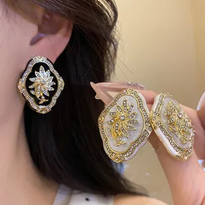 Detailed close-up of vintage rhinestone floral earrings with gold-tone frames