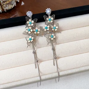 Detailed view of elegant silver butterfly and flower tassel earrings with rhinestones