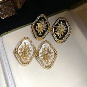 Exquisite close-up of vintage palace style floral stud earrings with sparkling crystals
