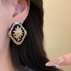 Vintage palace style flower stud earrings with rhinestones worn on an ear closeup view