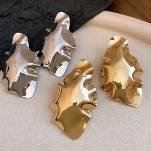 Irregular geometric pleated metal stud earrings in gold and silver finish