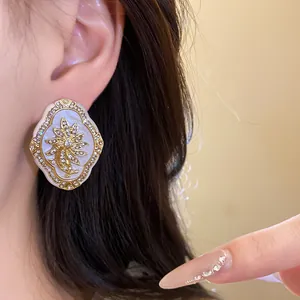 Detailed view of vintage palace style flower earrings with sparkling rhinestone studs