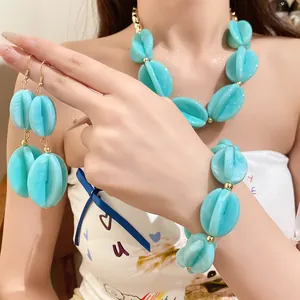 Detailed macro view of light blue marbled acrylic beaded necklace and earring set