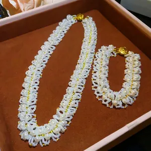 Elegant French style woven pearl necklace and bracelet set presented in a jewelry box.