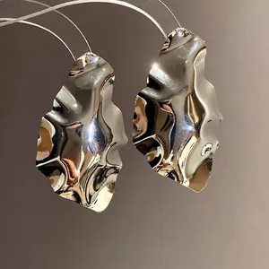 Elegant silver geometric crumpled metallic stud earrings with a glossy irregular finish