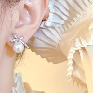 Detailed view of elegant pearl bow earring featuring shimmering crystals and soft luster