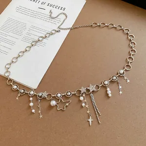 Close-up detail of silver-tone waist chain with faux pearls and rhinestone star charms