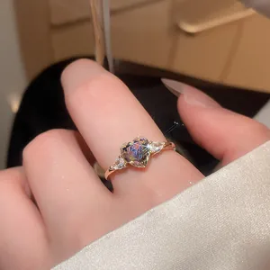 Close-up of a vintage-style gold ring with a sparkling heart-shaped zircon.