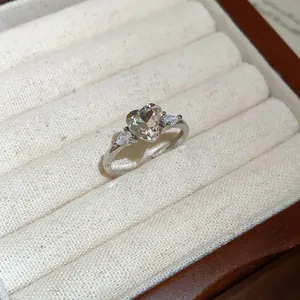 Detailed macro shot of vintage heart-shaped zircon silver adjustable ring in a display box
