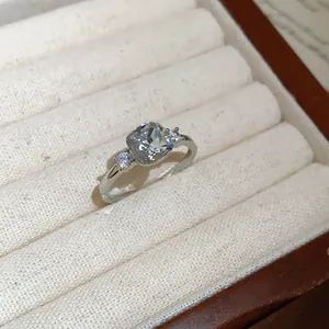 Close-up of cushion-cut zircon ring in silver finish on jewelry tray