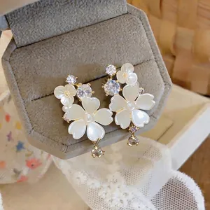 Elegant flower zircon stud earrings with gold plating and shell petals.