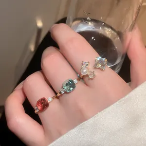 Macro view of vintage style adjustable rings with colorful zircons and pearls