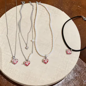 Detail view of sweet zircon heart necklaces in pearl, metal chain, and cord styles.