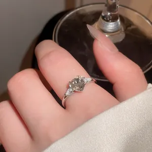 Close-up of a vintage-style silver ring featuring a sparkling heart-shaped grey zircon