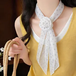 Close-up of white floral long scarf with a large decorative fabric rose flower