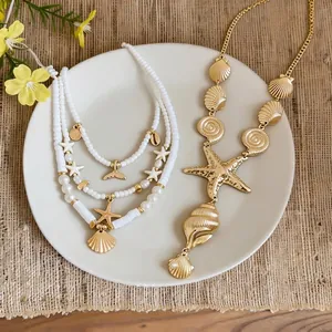Boho gold starfish and shell necklace set with white beads for beach vacations