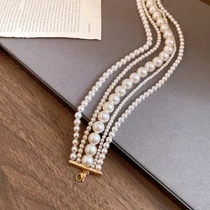 Elegant multi-strand faux pearl necklace featuring a French vintage chic design